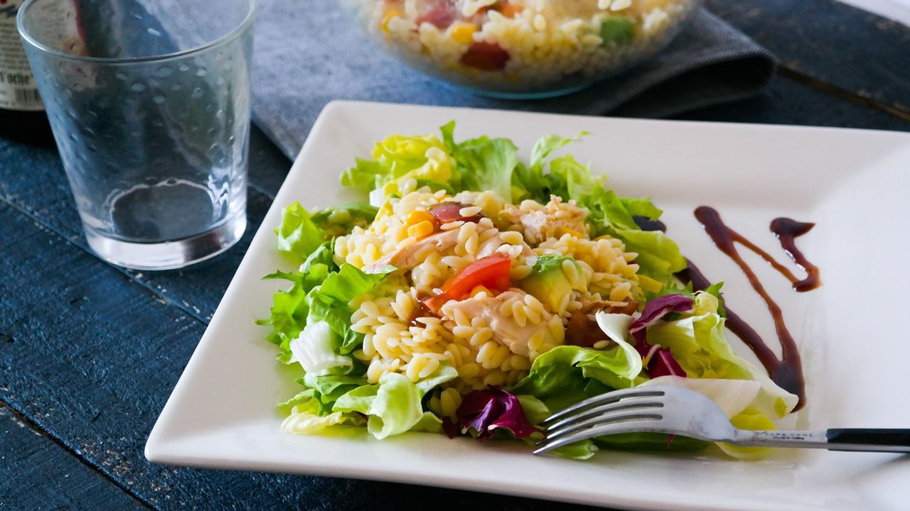 Ingredientes
Pasta de ensalada, 100 g
Tomate, 1
Aguacate, 1/2
Maíz dulce, 3 cucharadas soperas
Pechuga de pollo asada, 150 g
Mezcla de lechugas
Sal
Aceite de oliva virgen extra
Reducción de vinagre de Módena

Preparación: 15 min / Comensales: 2

1. Cocemos la pasta en agua abundante con sal durante el tiempo que indique el paquete, la escurrimos, la refrescamos bajo un chorro de agua fría, la volvemos a escurrir bien y la pasamos a un bol.
2. Añadimos el tomate cortado en dados, el aguacate, el maíz dulce y la pechuga de pollo asado troceada. Aliñamos al gusto con aceite y sal y reservamos hasta el momento de servir.
3. Para servir: Cuando vayamos a comer, ponemos una base de mezcla de lechugas en cada plato, repartimos la ensalada de pollo y orzo por encima y terminamos de aliñar con un poco de reducción de vinagre de Módena.

Fuente: Elespanol.com

