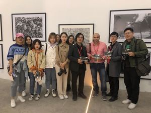 Zhang, curador de la Universidad de las artes de Shadong, muestra junto a sus alumnos, imágenes autografiadas por el fotógrafo dominicano Kelvin Naar.