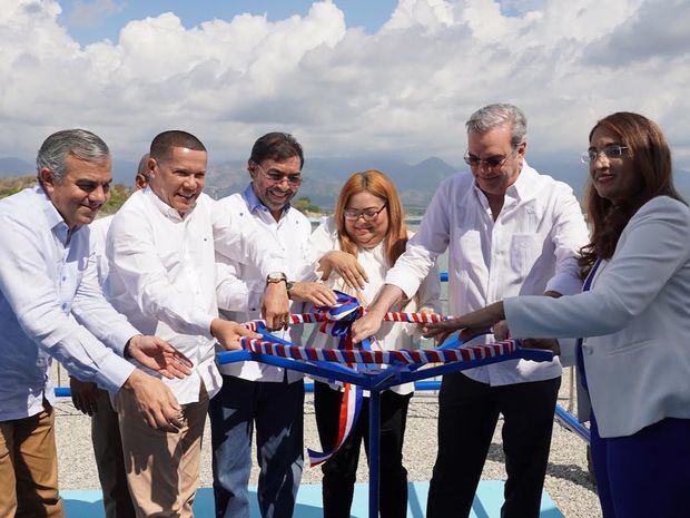 El presidente Luis Abinader Corona junto a Olmedo Caba Romano, director ejecutivo del INDRHI y otras autoridades abren manivela del reservorio durante inauguración.