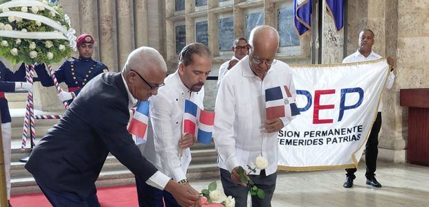 Fernando Arturo Santana, Juan Pablo Uribe y Miguel Estrella colocan una rosa en la llama votiva.