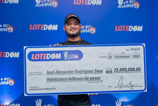 José Alexander Rodriguez exibe su cheque de 25 millones de pesos.