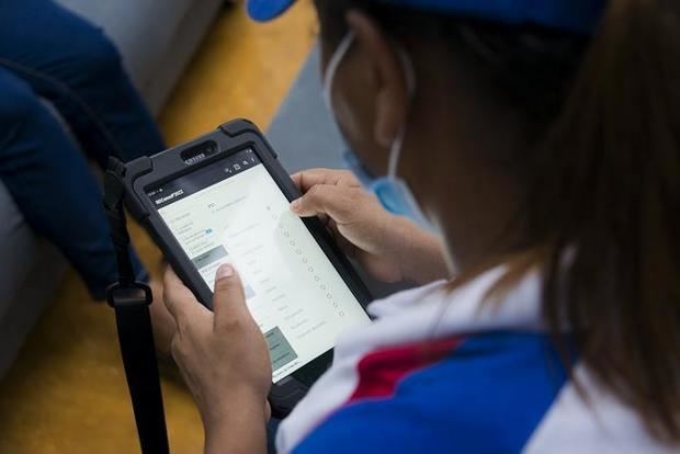 Trabajadora del Censo de Vivienda y Población en República Dominicana muestra tablet donde se registran los datos para el censo.