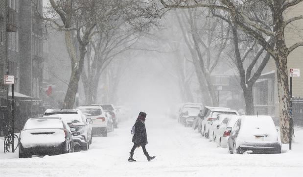 Un persona fue registrada este sábado al cruzar una calle de Brooklyn, bajo una intensa nevada que azota el noreste de Estados Unidos, en Nueva York, NY, EE.UU.