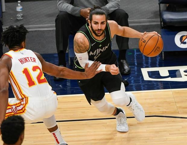 El español de Timberwolves Ricky Rubio (d) avanza con el balón frente a De'Andre Hunter de Atlanta Hawks.