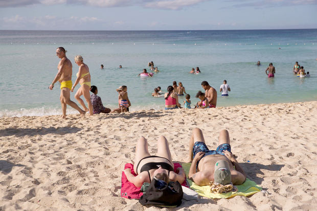 Grupos de personas disfrutan la playa en Bayahibe (R.Dominicana), en una fotografía de archivo.