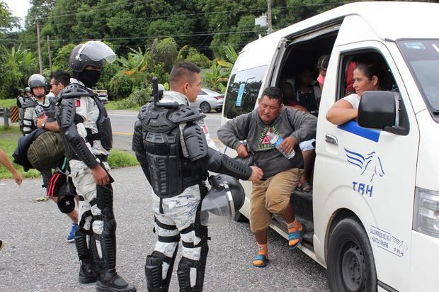 Migrantes centroamericanos reciben atención de personal de la Guardia Nacional en su caravana hacia la frontera con Estados Unidos, hoy, a su paso por Escuintla, México.