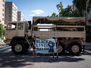 Dos personas protestan en un camión de la Guardia Nacional cerca de la Casa Blanca, donde ha habido una semana de protestas por la muerte de George Floyd, quien murió bajo custodia policial, en Washington, DC.