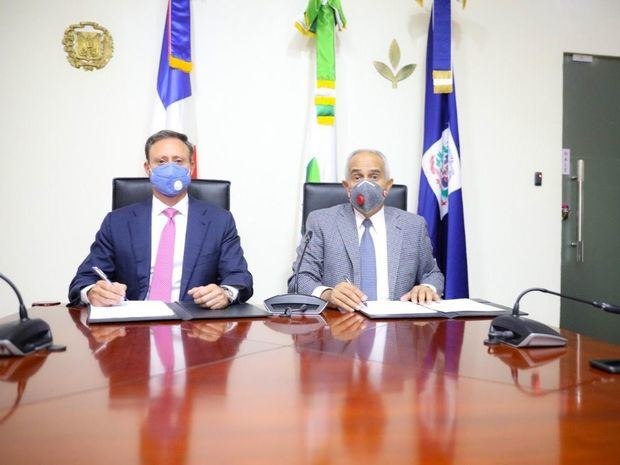 El procurador Jean Rodríguez y el ministro Osmar Benítez durante la firma del acuerdo que establece la implementación de programas orientados a la capacitación y fomento de la siembra de diversos cultivos y la crianza de animales.