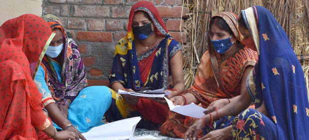 Miembros del Grupo de Productores Agrícolas contabilizando las cifras de las adquisiciones en el pueblo de Dhanapur, Uttar Pradesh, India.