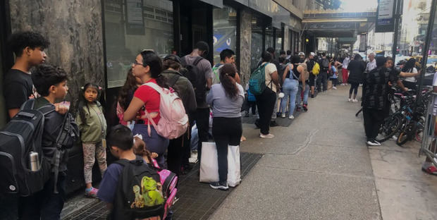 Inmigrantes hacen fila para ser atendidos en el Hotel Roosevelt, en Nueva York (Estados Unidos).