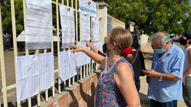 Una votante venezolana se busca en un listado en el centro de votación del colegio Lucila Palacios, Maracaibo.