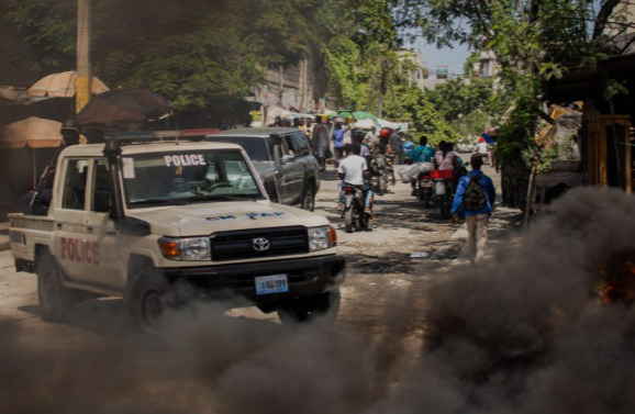 Integrantes de la policía haitiana patrullan durante una protesta.