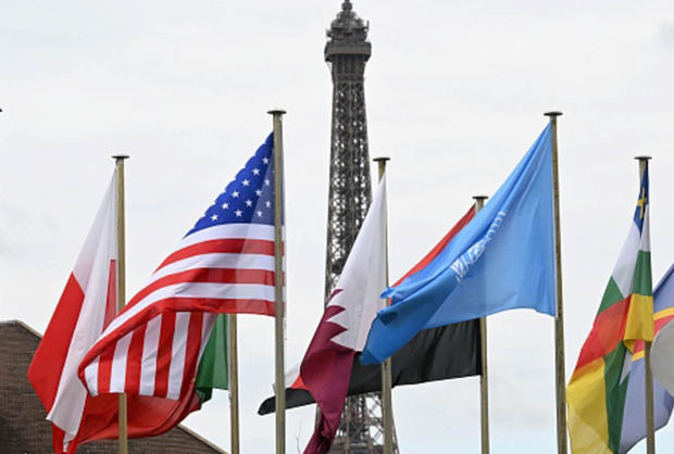 La bandera de Estados Unidos ondea frente a la Torre Eiffel, un sitio designado por la UNESCO como Patrimonio Mundial.