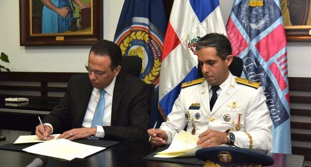 El ministro Antonio Peña Mirabal y el general de brigada de la Fuerza, coronel Juan Carlos Torres Robiou, firman el acuerdo.
