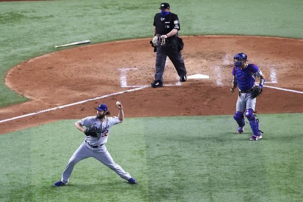 El jugador de los Dodgers Los Ángeles Clayton Kershaw (i) lanza una bola ante los Rays de Tampa Bay, durante el quinto partido de la Serie Mundial de las Grandes de Béisbol disputado en el Globe Life Field de Arlington, Texas, EE.UU.