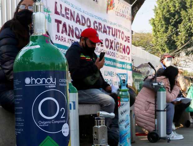 Fotografía de archivo fechada el 8 de enero de 2021, que muestra a un grupo de personas mientras esperan turno para la carga de oxígeno de forma gratuita, en la alcaldía de Iztapalapa, en Ciudad de México, México.