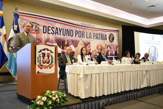 Wilson Gómez Ramírez, presidente del Instituto Duartiano, pronuncia las palabras centrales del acto. Figuran los integrantes de la mesa de honor, desde la izquierda, Eduardo Gautreau de Wind y Carmen Herrera, vocales del Instituto Duartiano; Pilia Moreno, tesorero; Jacinto Pichardo, vicepresidente; Rafaela Mesa, secretaria general; Víctor Zabala, gobernador de la Casa y Museo de Duarte; y Robinson Cuello, vocal.
