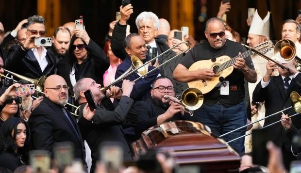 El féretro de Willie Colón entró a la iglesia rodeado de trombonistas y otros músicos.